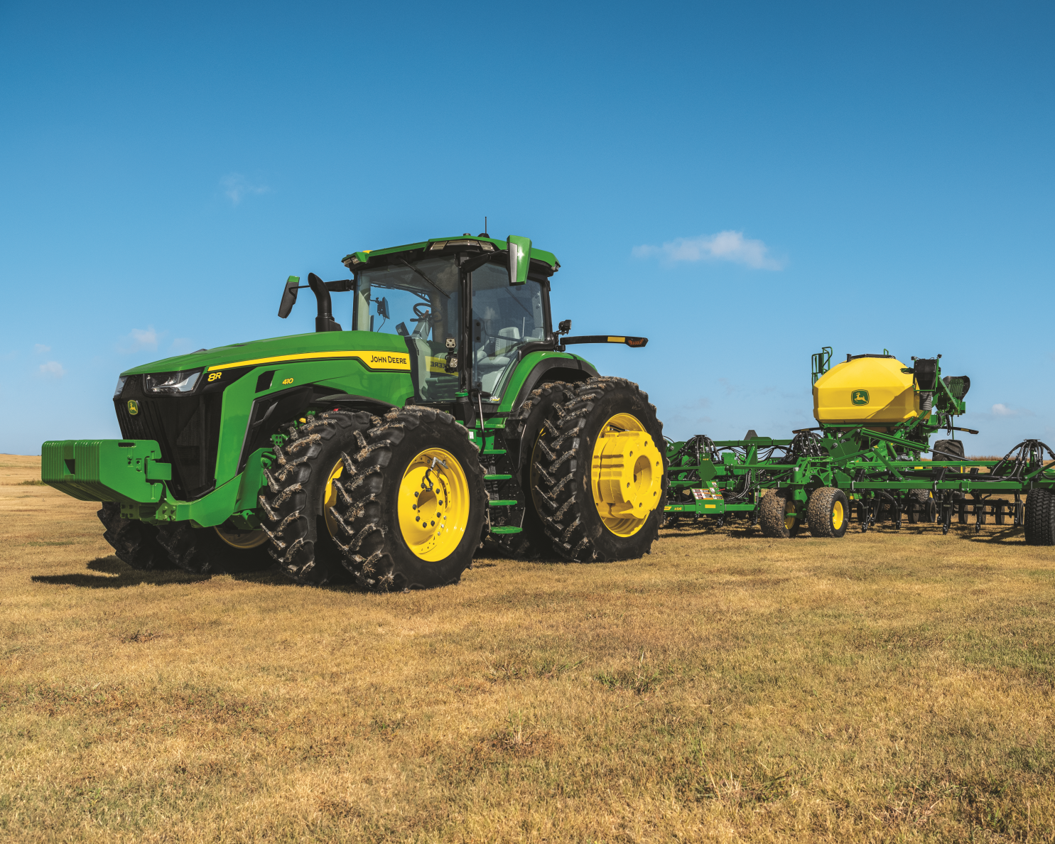 John Deere tractor and seeding equipment in a field