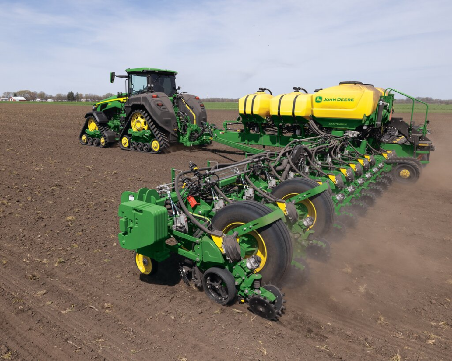 John Deere tracked tractor pulling a planter