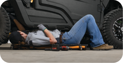 Podolinsky technician working underneath equipment
